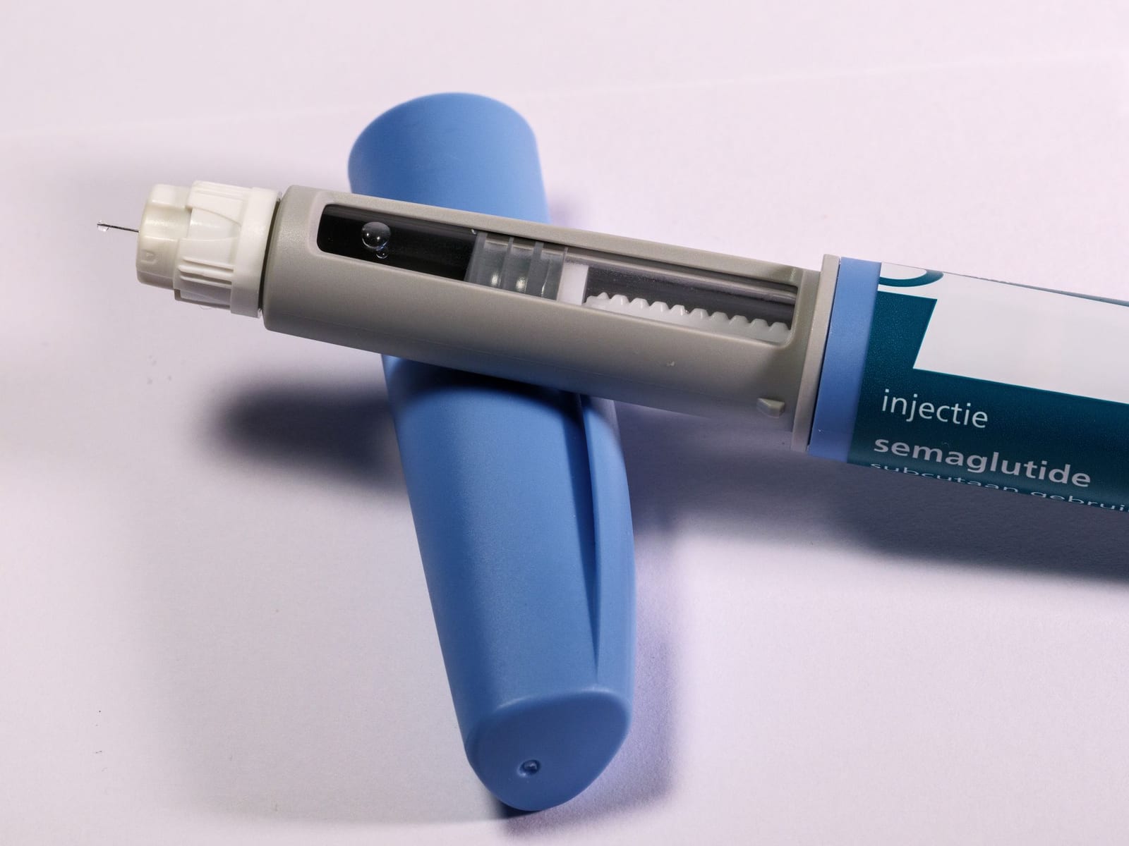 Close-up of a semaglutide weekly injection pen with the cap removed